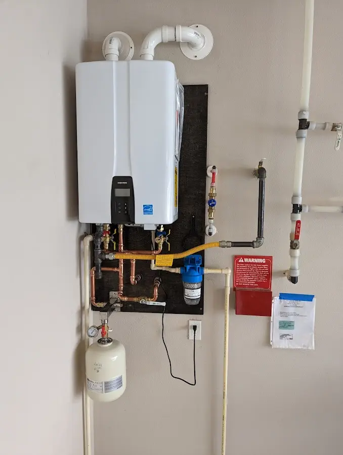 Professional plumber installing copper piping in a Willard home